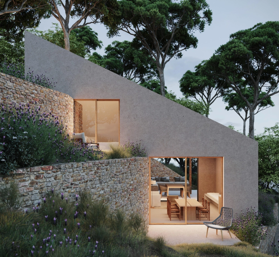 House in Tamariu integrated among stone walls and Mediterranean vegetation, with minimalist architecture that gently adapts to the slope of the terrain. Large openings connect the interior spaces with the outdoors, creating a warm, intimate atmosphere open to the natural landscape of the Costa Brava.