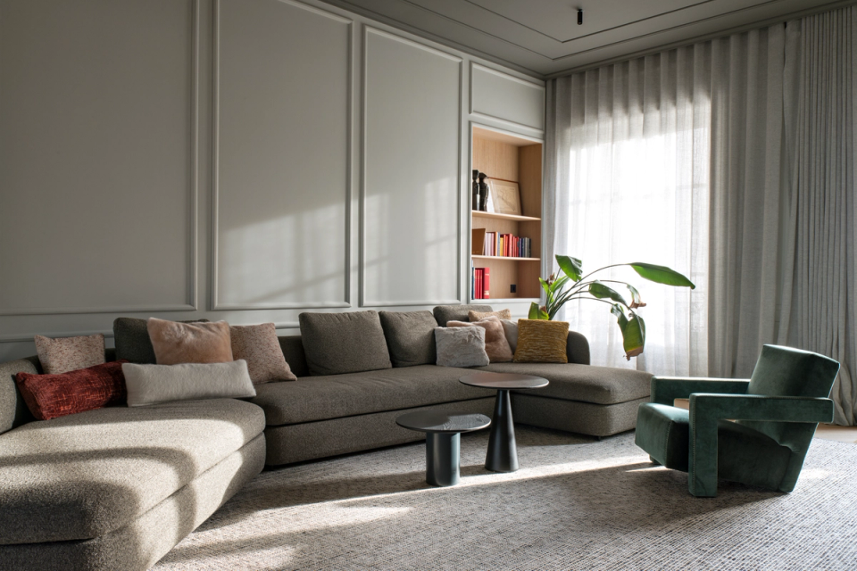 The interior renovation of this living room creates an elegant and welcoming atmosphere through a balanced combination of classical architecture and contemporary furniture. Ornamental moldings, natural fabrics, and light filtered through large windows add sophistication and warmth, while the open layout enhances comfort and the feeling of spaciousness within the interior spaces.