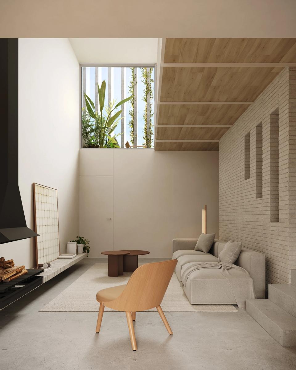 Houses in Bescanó with a contemporary living room illuminated by a vertical courtyard that brings natural light and vegetation into the interior spaces. These houses in Bescanó combine warm materials, wooden ceilings, and an open layout to create a peaceful and comfortable atmosphere.