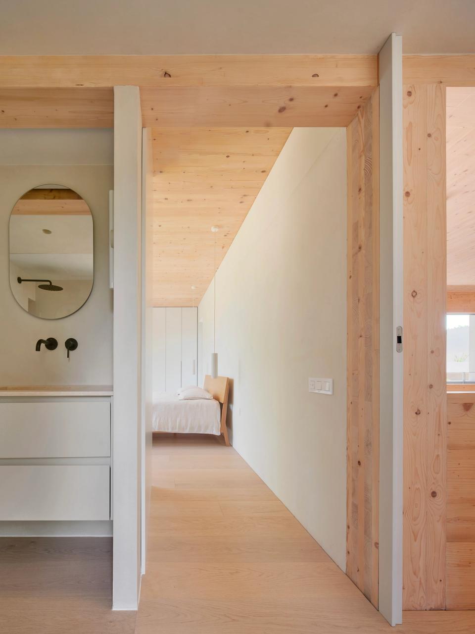 House in Girona with an architectural section showing the relationship between different interior levels, open spaces, and the connection with the outdoors. This house in Girona is designed to maximize natural light, double-height spaces, and integration with the garden and swimming pool