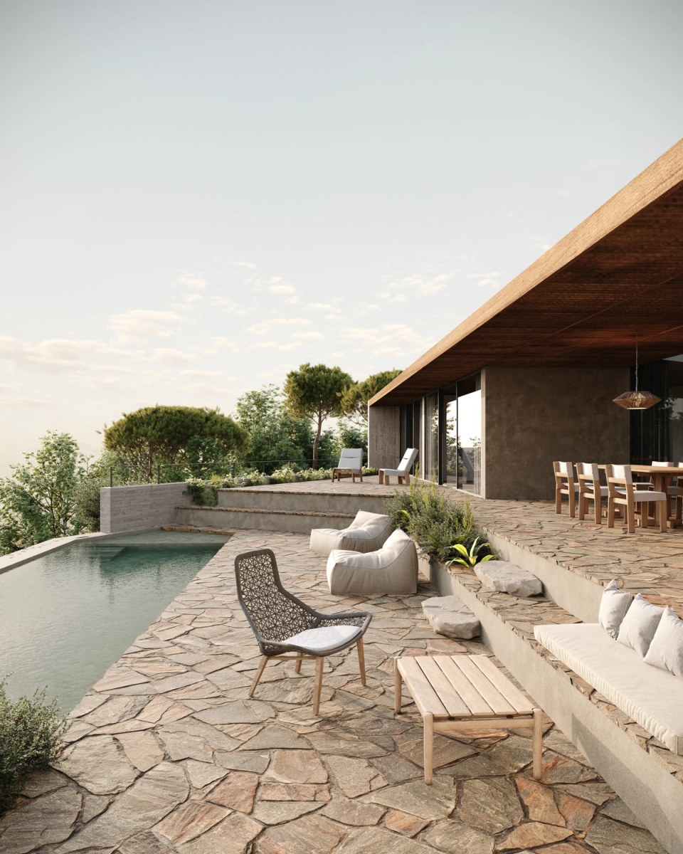Terraces and outdoor spaces of the detached house conceived as a natural extension of the home, with architecture open to the landscape and materials that dialogue with the Mediterranean surroundings. The pool, stone platforms, and seating areas create a serene, luminous atmosphere connected with nature