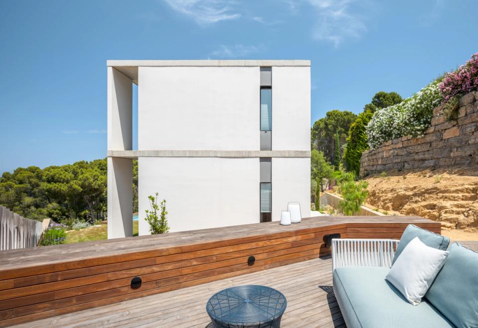 Minimalist detached single-family home with pure volumes, large openings, and outdoor spaces designed to integrate with the Mediterranean landscape. The combination of concrete, wood, and vegetation reinforces the project’s contemporary character.