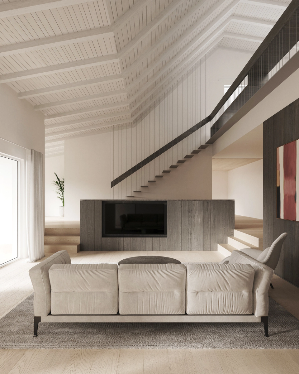 Interior renovation of the double-height living room that gives spaciousness to the space. This interior renovation combines top quality materials in tons and textures that create a warm atmosphere