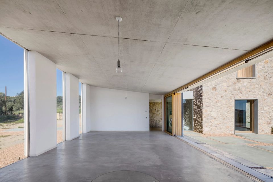  Exterior area of the house, porch that allows to give amplitude and visual continuity, with continuous pavements and mineral textures, create an area of elegant, functional and balanced passage. Integral reform of a farmhouse made by 05 AM arquitecture.