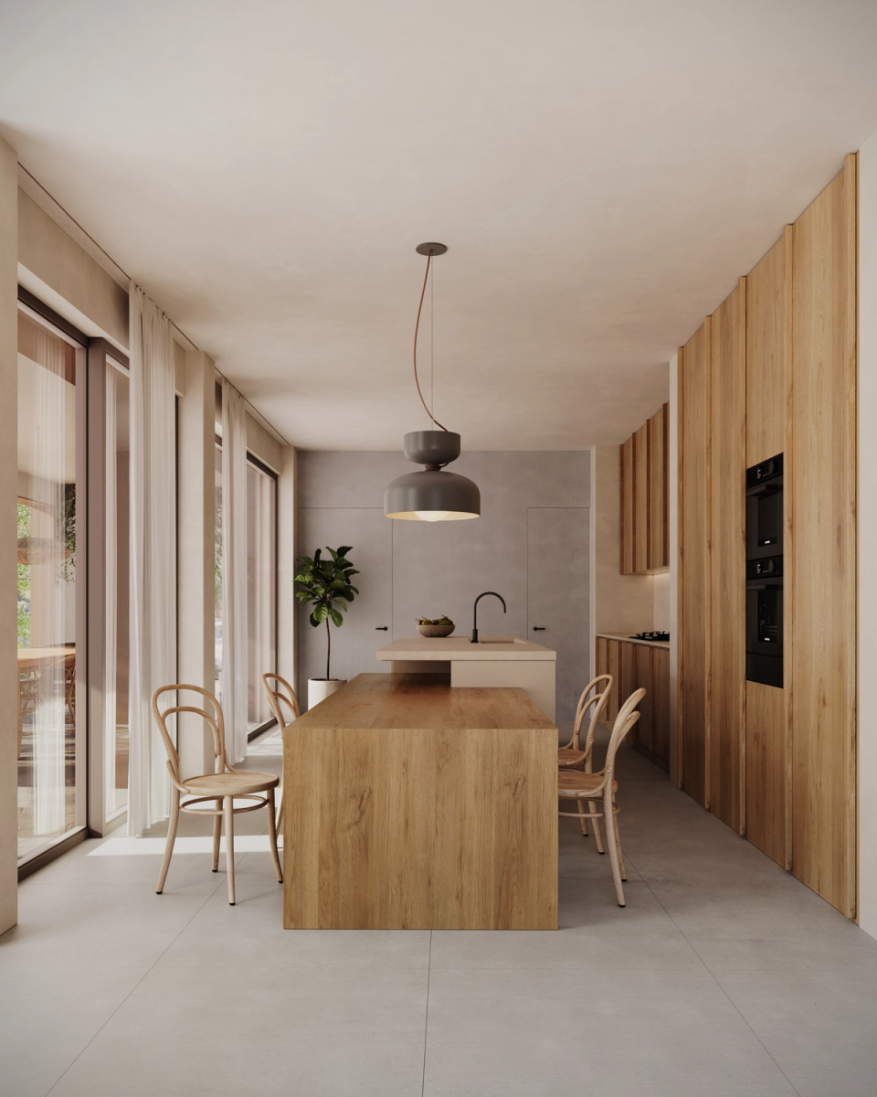 The renovation and extension of this home embraces warm and timeless interiors, where natural wood and light become the main protagonists. The kitchen-dining area has been designed as an open, functional, and serene space, with large openings to the outdoors that enhance the connection with the garden and provide visual spaciousness throughout the home.