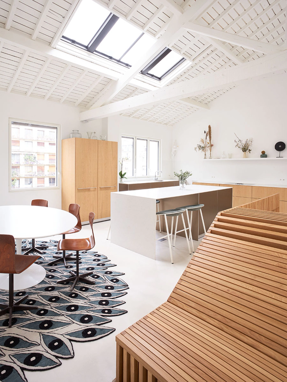  This full renovation enhances brightness and spaciousness through the restoration of the original roof structure with exposed timber beams and large skylights. The combination of neutral tones, minimalist furniture and natural wood creates a warm, contemporary and functional atmosphere designed to connect the different common areas in a fluid and elegant way.