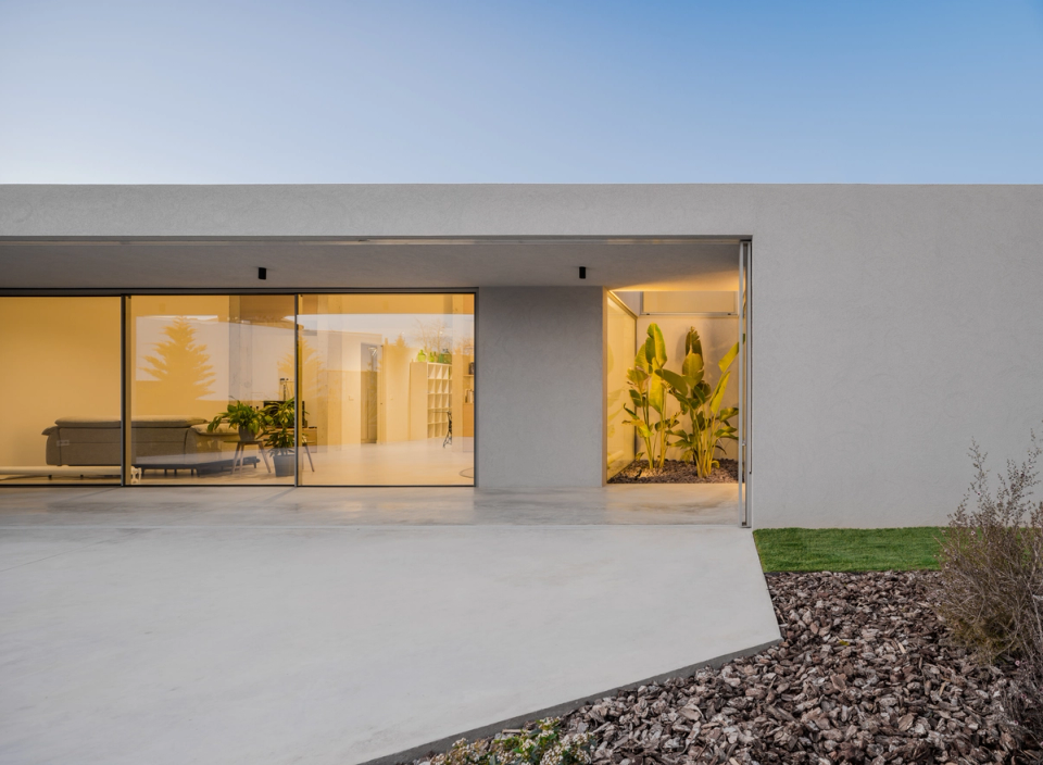 This single-family home combines essential architectural lines with a direct relationship between interior spaces and landscaped courtyards. Large glazed openings, material continuity, and warm lighting create a contemporary, bright, and welcoming atmosphere designed to enhance well-being and connection with the outdoors.