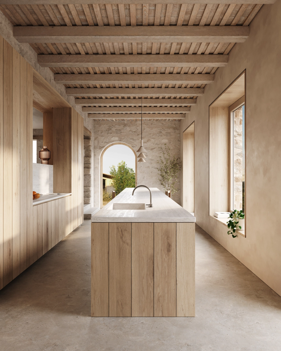 The renovation of this farmhouse creates warm and bright spaces where natural stone, wood, and light define the interior atmosphere. The kitchen opens to the landscape through a serene and timeless architecture. Natural materials strengthen the connection with the surroundings and bring authenticity to the project. This home renovation reinterprets the traditional essence of the masia from a contemporary perspective.