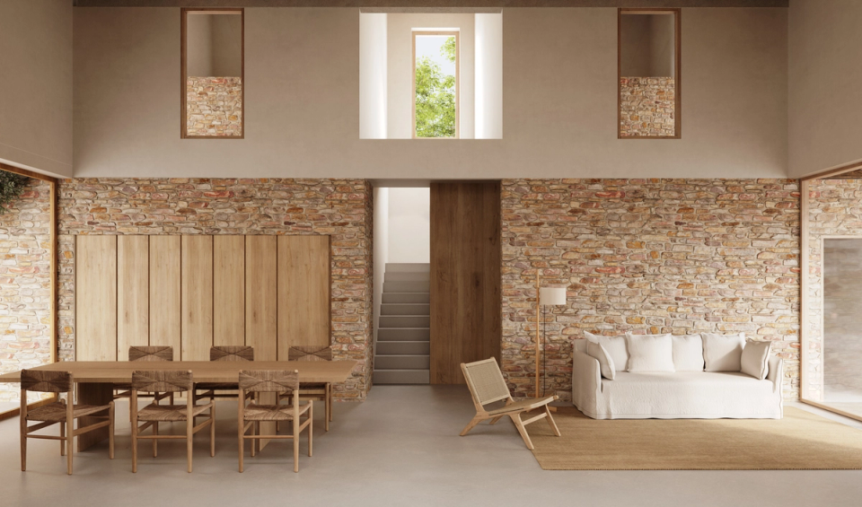 "Interior of the house in Tamariu with spacious, open spaces bathed in natural light, where reclaimed stone walls and wood create a serene and welcoming Mediterranean atmosphere. The architecture embraces material simplicity and visual connection between the different interior spaces and the outdoor environment