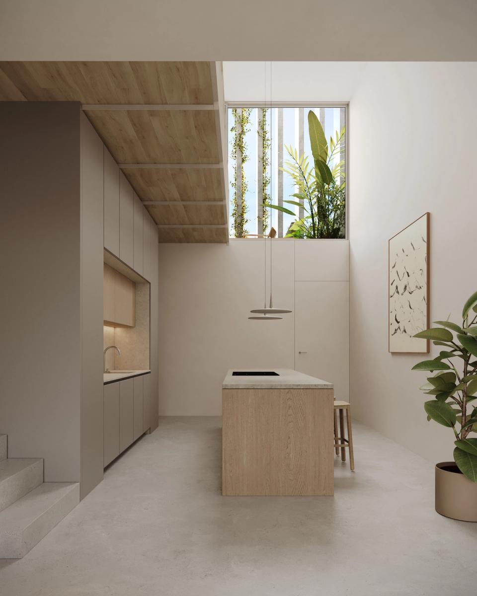 Houses in Bescanó with a minimalist kitchen illuminated by a vertical courtyard that introduces vegetation and natural light into the interior spaces. These houses in Bescanó combine warm materials, high ceilings, and contemporary architecture designed to enhance comfort and connection with the outdoors.