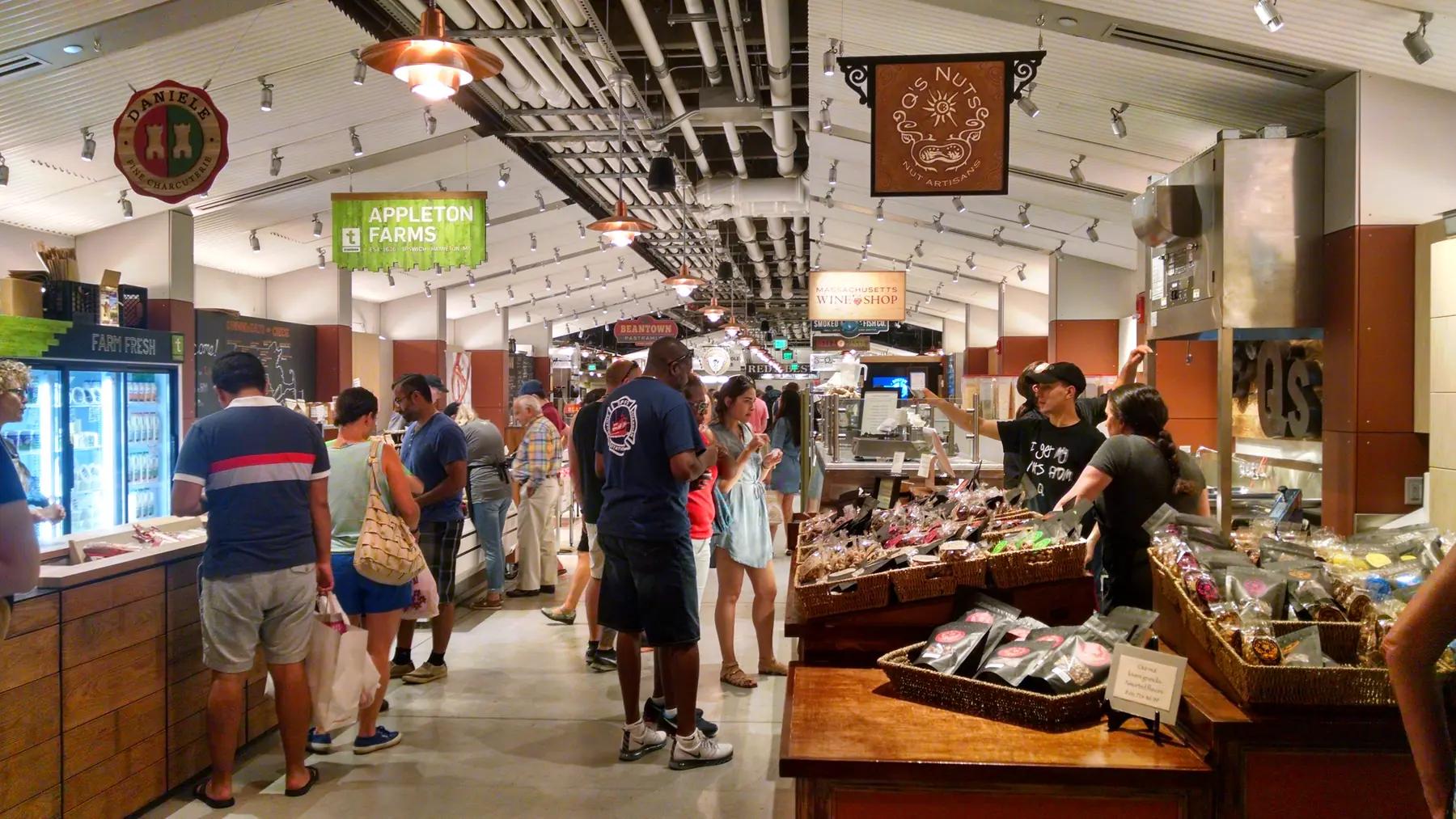 Shoppers browsing food stalls inside Boston Public Market