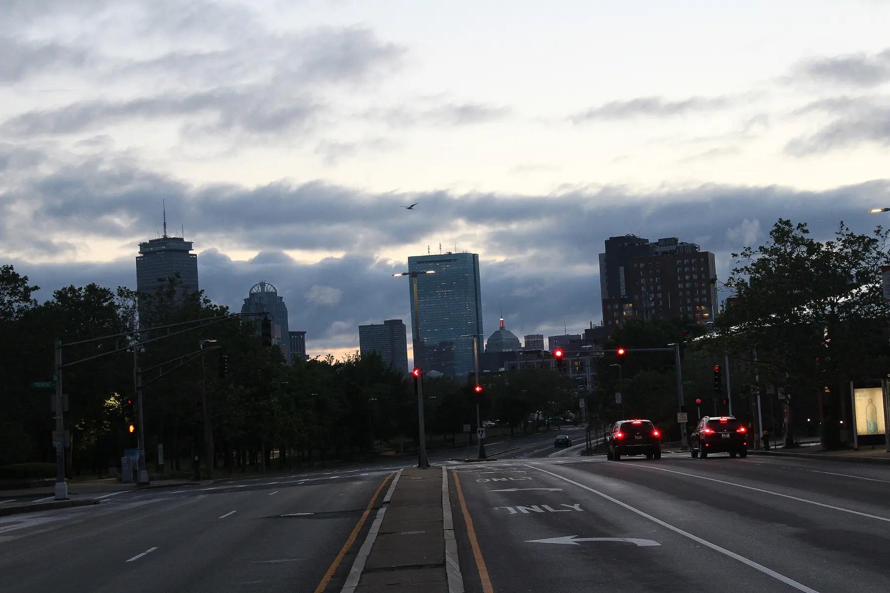 An almost empty Columbus Avenue before sunrise, looking toward the Boston skyline from Roxbury Crossing