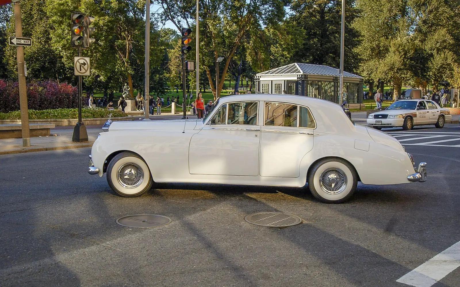 A vintage Rolls-Royce Silver Cloud driving on Tremont Street in Boston