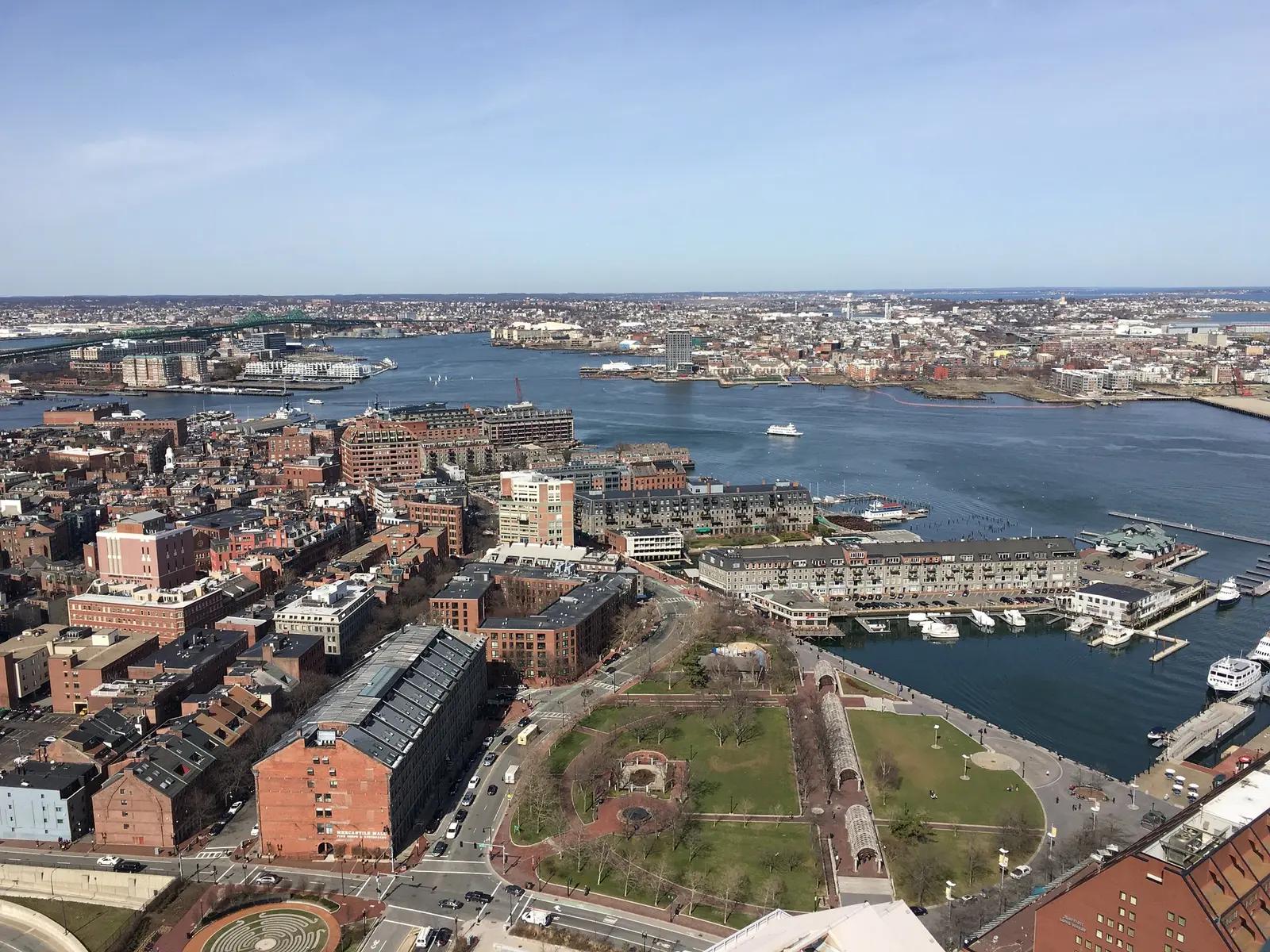 Aerial view over Christopher Columbus Waterfront Park, the North End and Boston Harbor