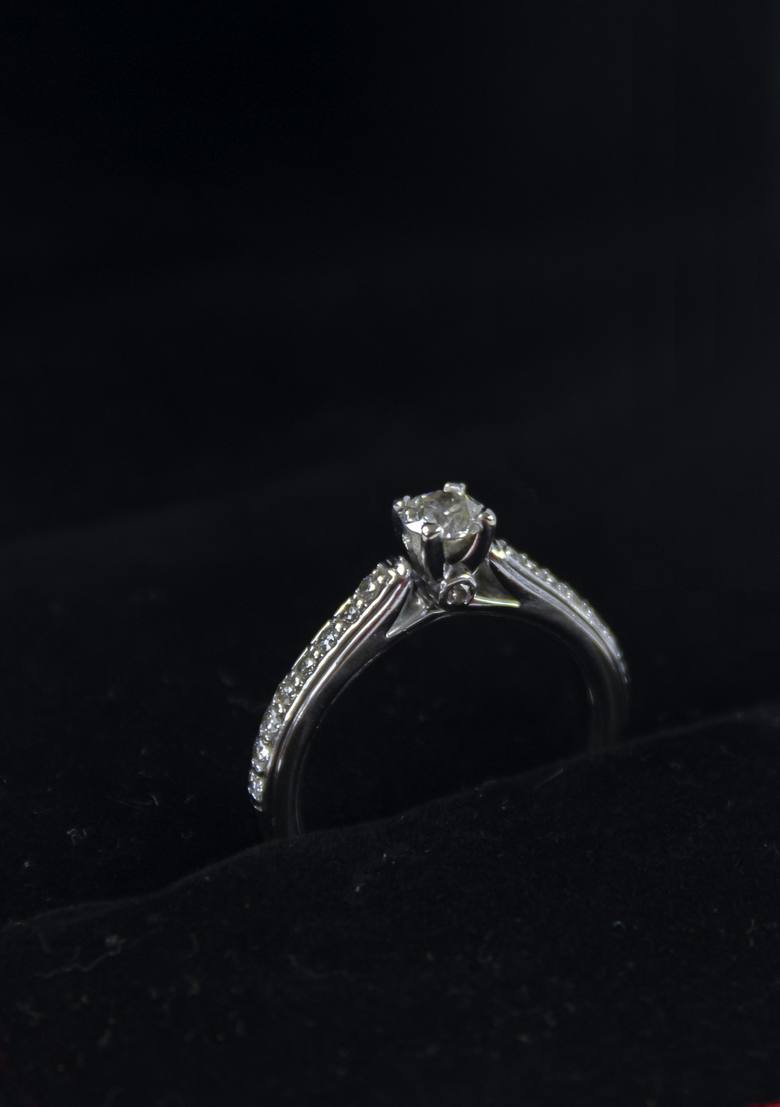 A loose diamond held with tweezers