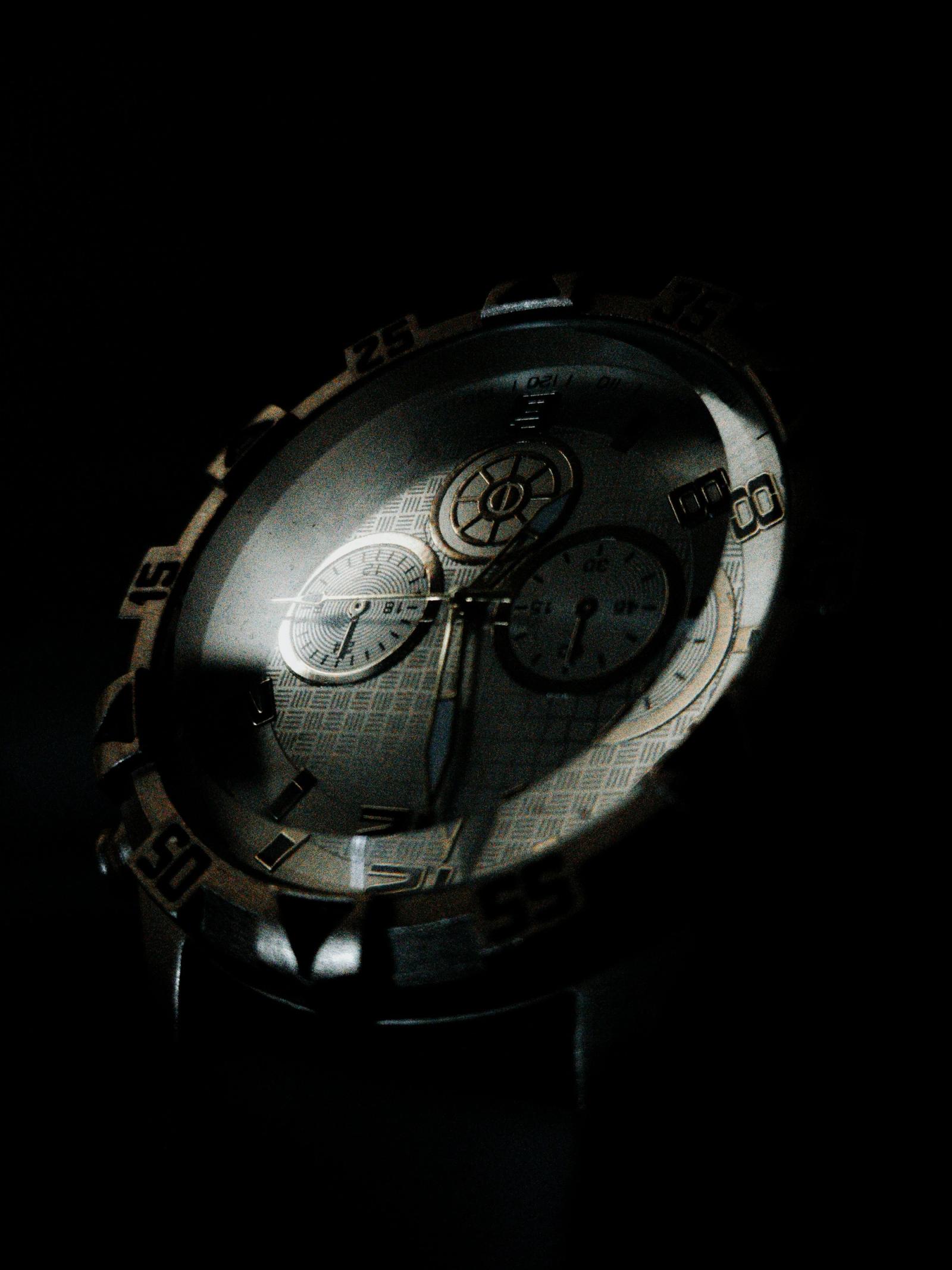 A luxury watch dial and bezel in low light
