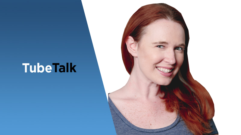 Smiling woman with red hair next to TubeTalk logo on a blue and white background