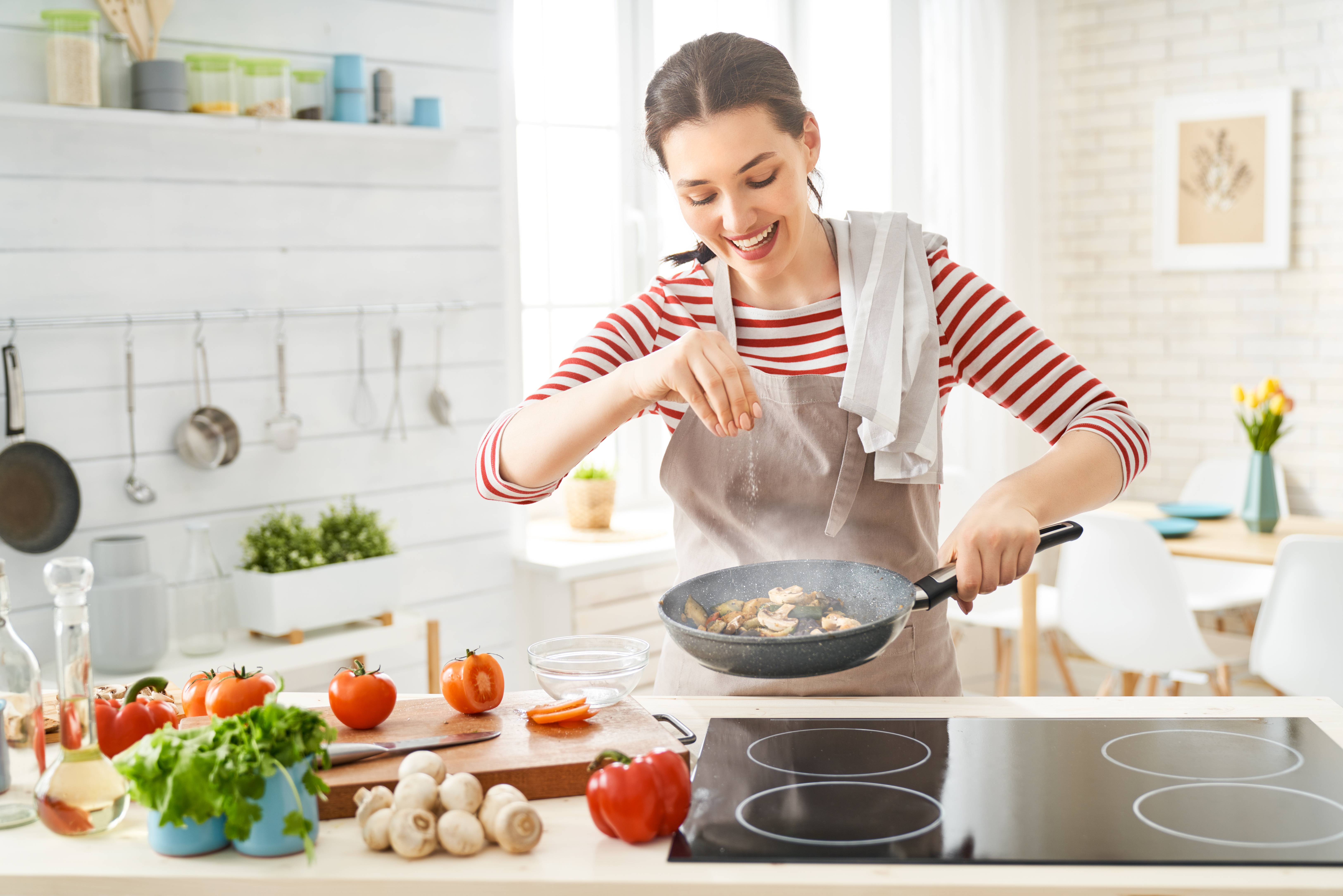 Woman cooking in the kitchen and smiling