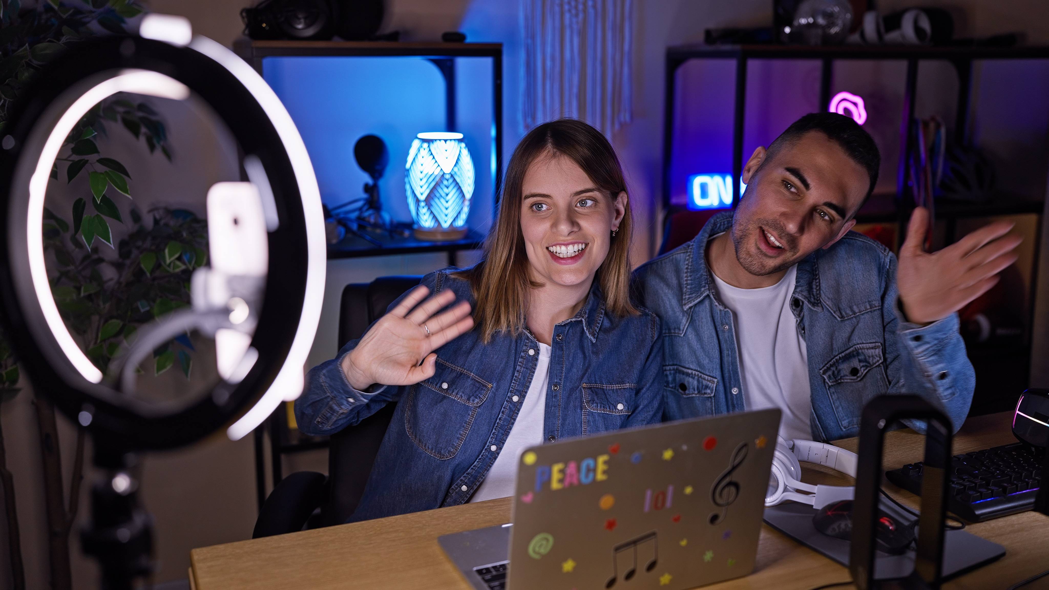 Two creators waving at the camera