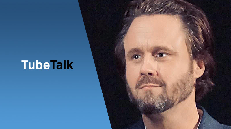Man with beard and short hair next to blue background with "TubeTalk" text logo