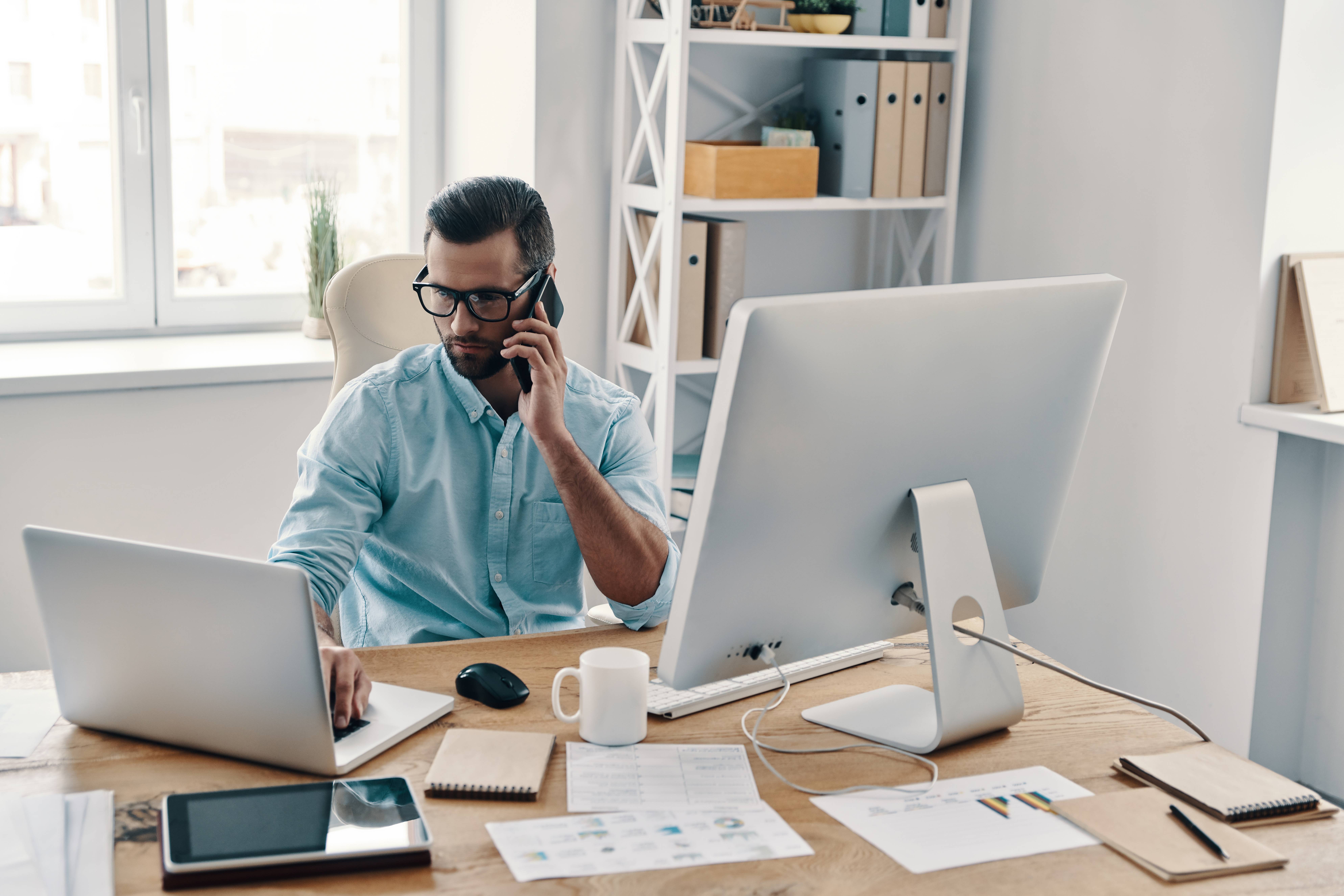 Man managing multiple devices