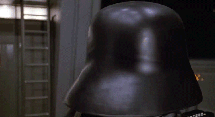 Close-up of a shiny black helmet resembling a stormtrooper from a sci-fi film.