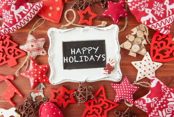 Happy Holidays message on chalkboard with red and white Christmas decorations around it