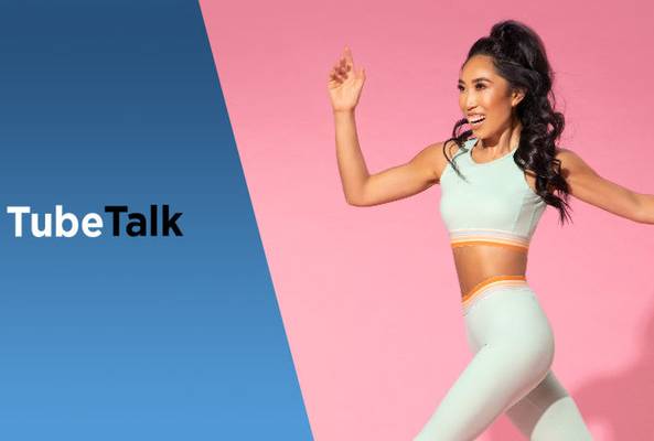 Smiling woman in activewear jumping with TubeTalk logo on blue and pink background