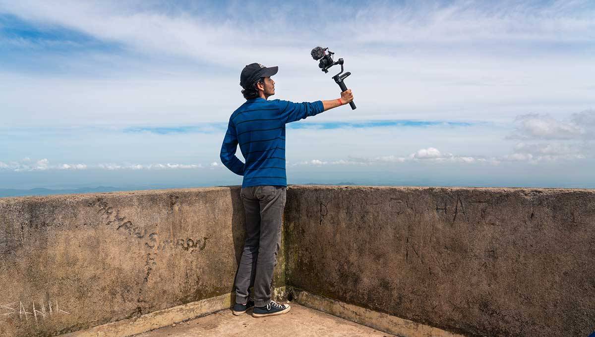 Male vlogger fiming outside