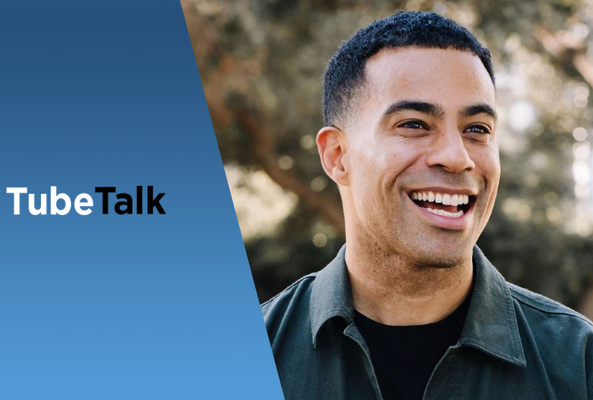 Smiling man with short hair beside blue background featuring TubeTalk logo and branding text
