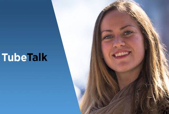 Smiling woman next to blue panel with TubeTalk logo, video communication concept