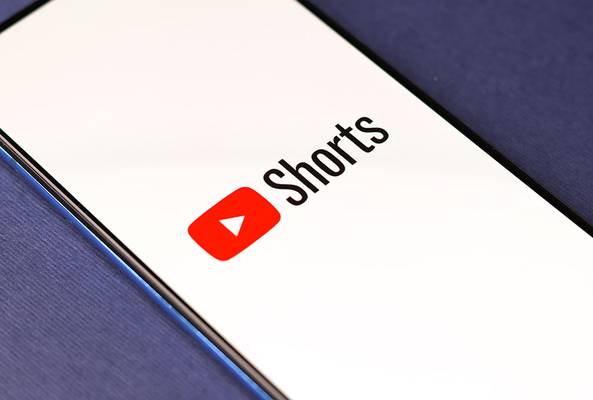 Smartphone screen displaying the YouTube Shorts logo on a white background.