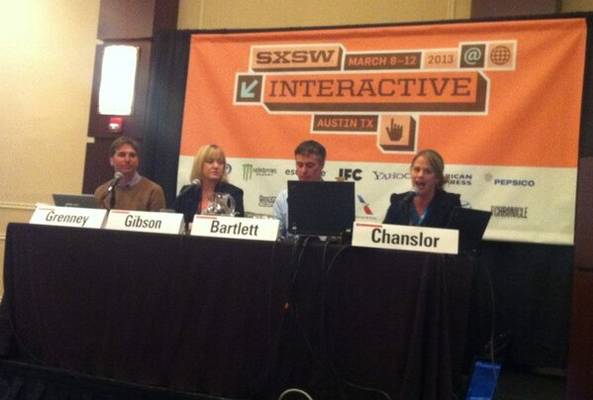 Panelists speaking at SXSW Interactive 2013 conference in Austin, Texas, featuring laptops.
