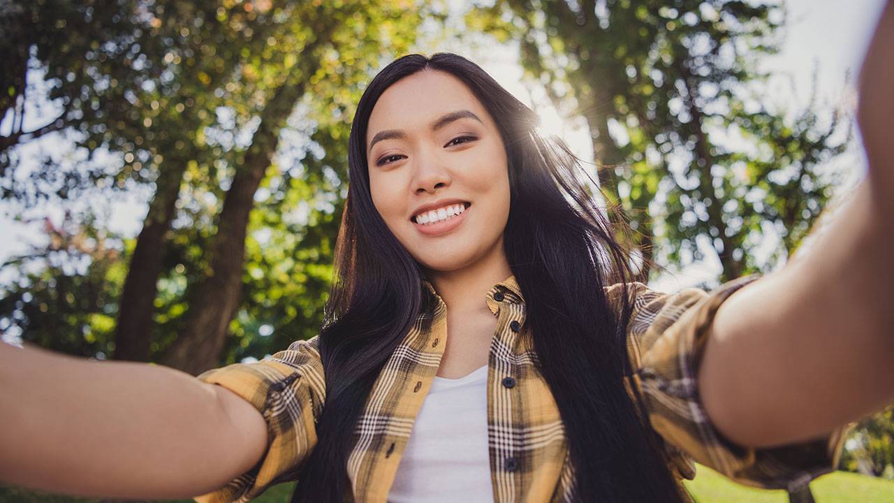 Woman holding camera in selfie position