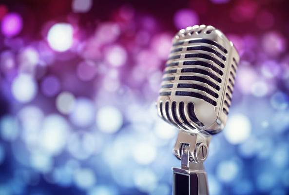 Vintage silver microphone with bokeh lights background for music or podcast concepts