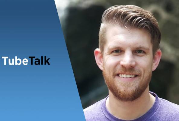 Smiling man with beard beside blue background and TubeTalk logo for video podcast.