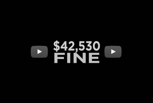 $42,530 fine text displayed on black background with YouTube play button icons on sides