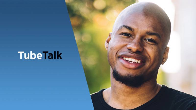 Smiling man with black shirt next to TubeTalk logo on a blue gradient background