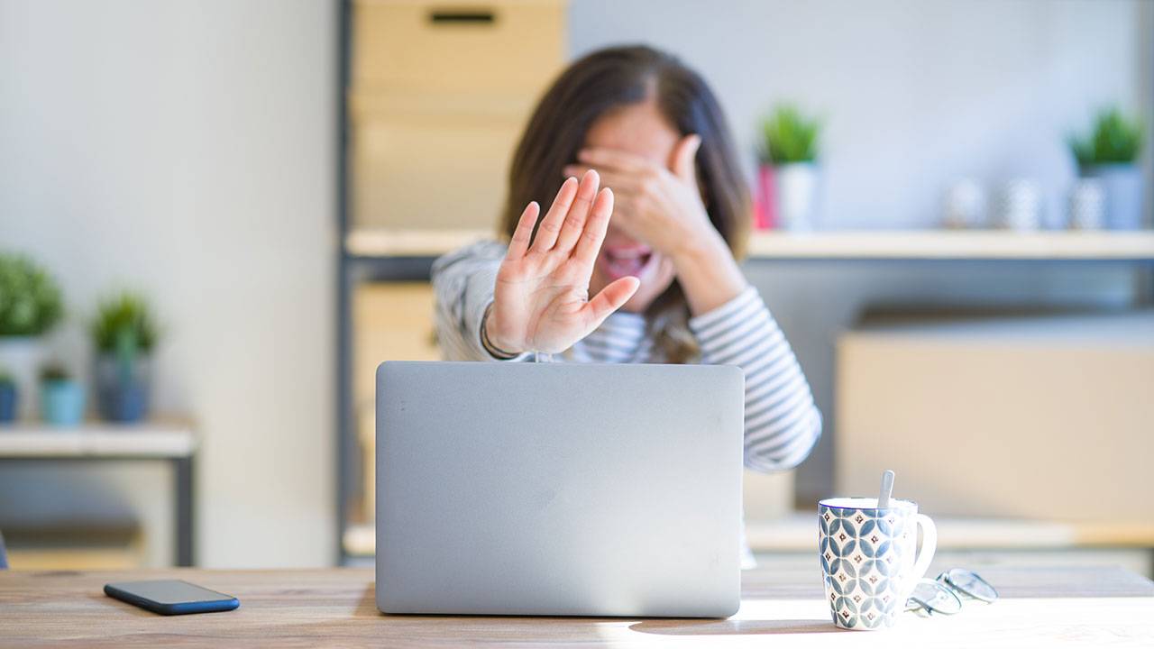 Embarrassed woman covers her face in shock