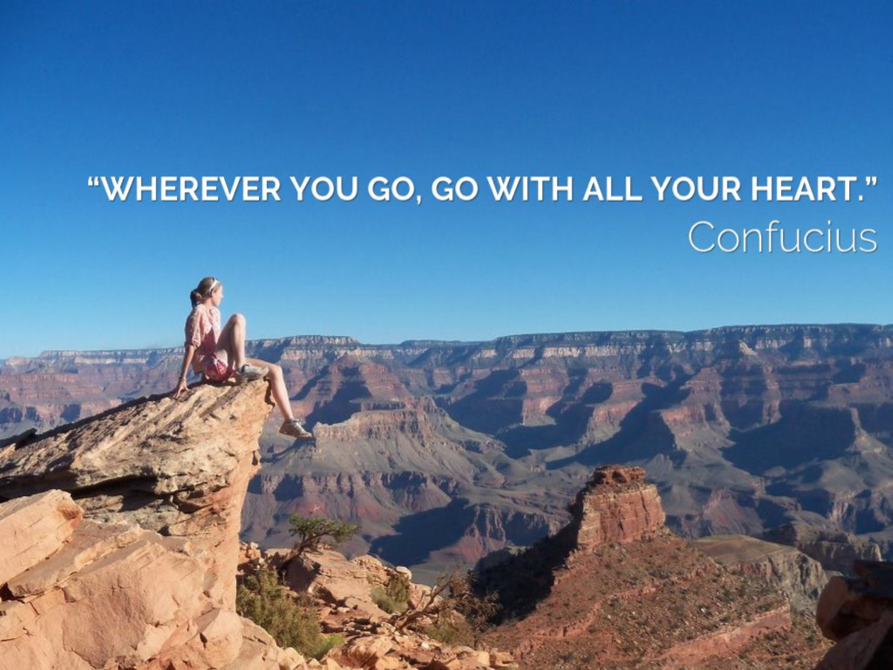 Woman sitting on rock overlooking Grand Canyon with Confucius inspirational quote
