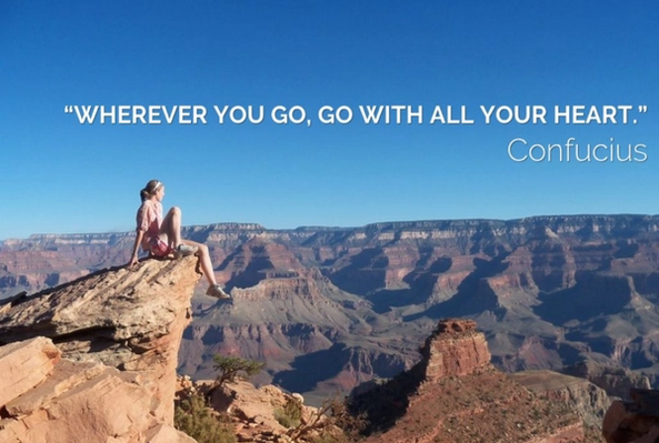 Woman sitting on rock overlooking Grand Canyon with Confucius inspirational quote