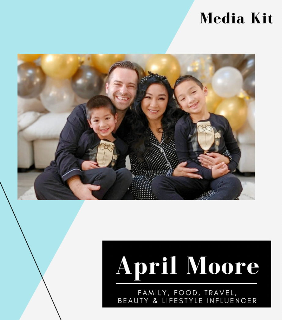 Family of four smiling in cozy setting with gold and white balloons in background