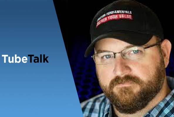 Close-up of man with glasses and cap beside TubeTalk logo on blue and black background