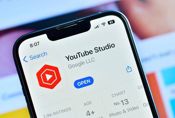 Close-up of YouTube Studio app page on smartphone with open button visible