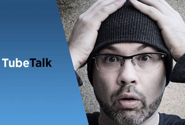 Man wearing glasses and beanie looking surprised next to TubeTalk logo on blue background