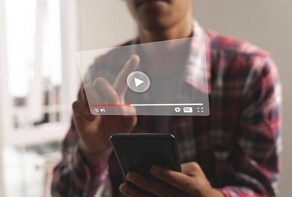 Person using smartphone with transparent floating video player interface on screen.