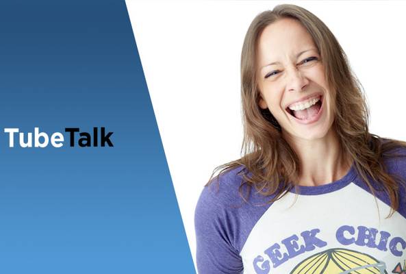 Smiling woman in geek chic shirt with TubeTalk logo on blue and white background