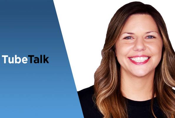 Smiling woman with long hair on white background next to TubeTalk logo on blue panel.