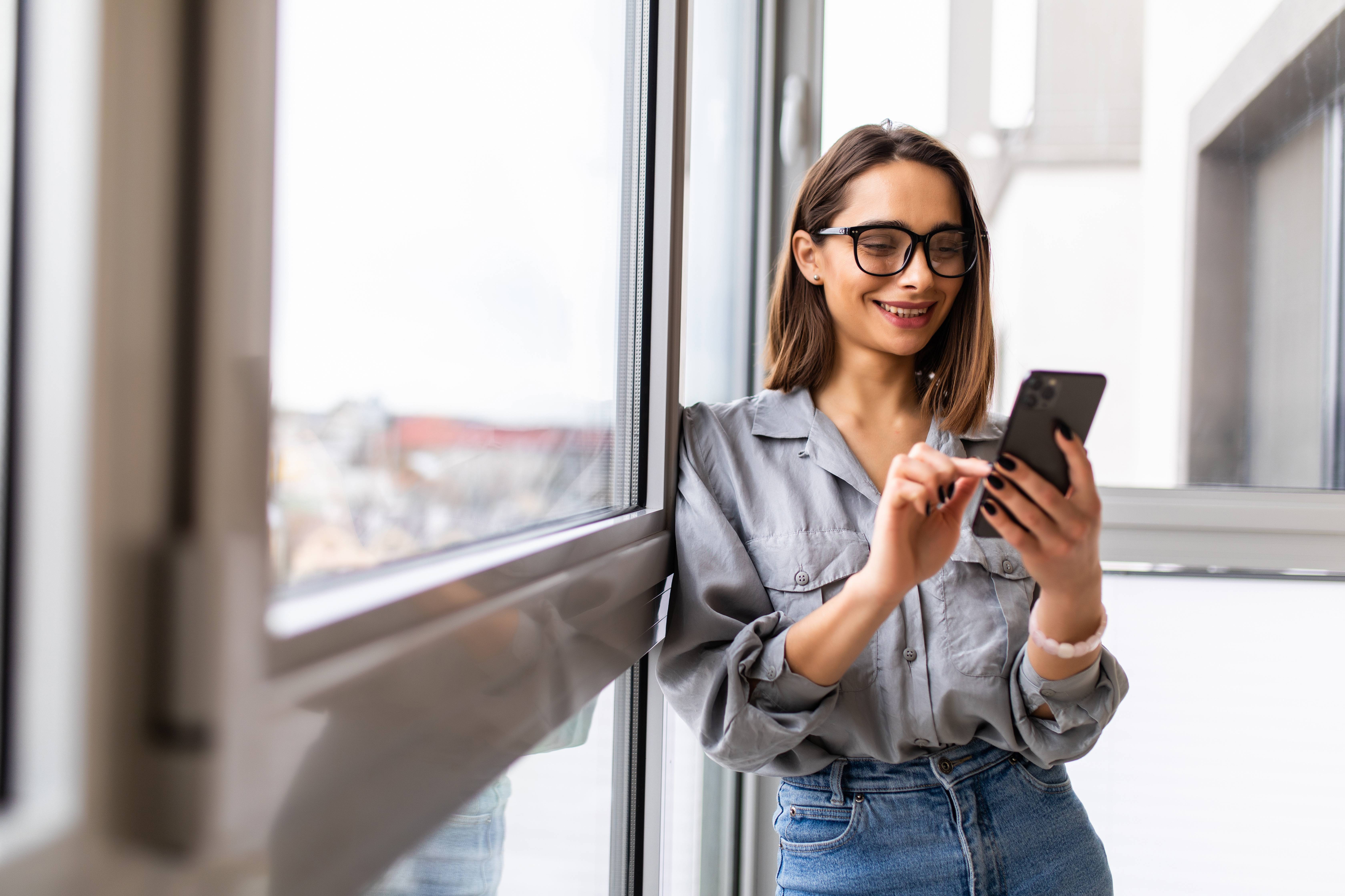Woman looking at her phone and smiling