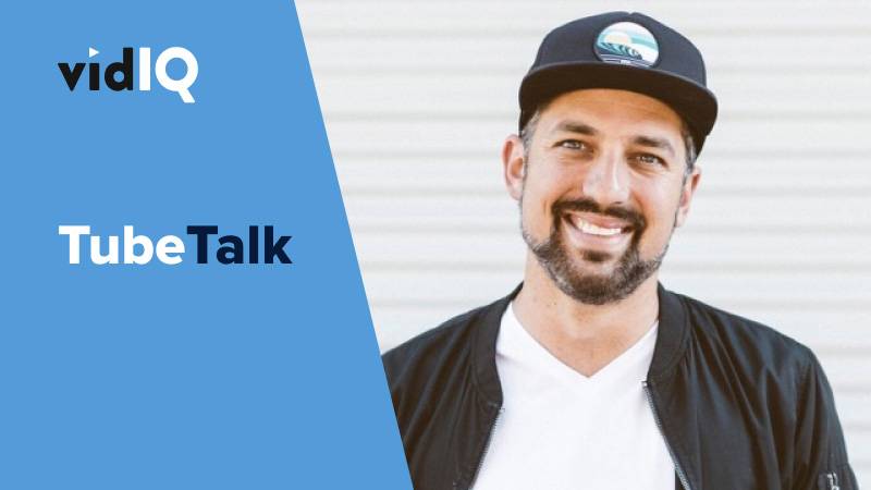 Smiling man wearing a cap and jacket next to vidIQ Tube Talk branding on blue background